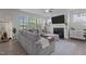 Comfortable living room with a fireplace, mounted TV, a large sectional sofa, and natural light at 604 Craftsman Ridge Trail Trl, Knightdale, NC 27545
