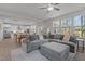 Open-concept living room featuring a large gray sectional sofa and views of the modern kitchen and dining area at 604 Craftsman Ridge Trail Trl, Knightdale, NC 27545