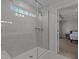 Bright shower with a glass enclosure and a window overlooking a treed area at 604 Craftsman Ridge Trail Trl, Knightdale, NC 27545