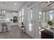 Kitchen access to a sunroom featuring natural light, white trim, and views of the backyard at 604 Craftsman Ridge Trail Trl, Knightdale, NC 27545