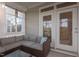 Cozy sunroom with wicker furniture and lots of natural light provided by many windows and sliding doors at 604 Craftsman Ridge Trail Trl, Knightdale, NC 27545
