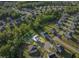 Overhead shot of the home on a large lot surrounded by mature trees in a residential area at 6404 Fauvette Lane Ln, Holly Springs, NC 27540
