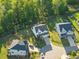 Aerial view showing the property's placement in a well-maintained neighborhood with mature trees at 6404 Fauvette Lane Ln, Holly Springs, NC 27540