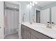 Clean bathroom with double sinks, large mirror, and a separate toilet and shower area, designed for functionality at 6404 Fauvette Lane Ln, Holly Springs, NC 27540