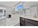 Bright bathroom featuring double vanity, soaking tub, subway tile, and a window with a scenic view at 6404 Fauvette Lane Ln, Holly Springs, NC 27540