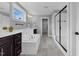 Elegant bathroom featuring a soaking tub, a glass-enclosed shower, and a dual-sink vanity with dark cabinets at 6404 Fauvette Lane Ln, Holly Springs, NC 27540