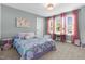 Cozy bedroom with ample natural light, featuring pink accents, a study desk, and carpeted floors at 6404 Fauvette Lane Ln, Holly Springs, NC 27540