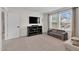 Versatile bonus room featuring a TV, console table, and comfortable seating near a bright window at 6404 Fauvette Lane Ln, Holly Springs, NC 27540