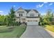 Charming two-story home with a well-manicured lawn and a spacious two car garage and inviting front porch at 6404 Fauvette Lane Ln, Holly Springs, NC 27540