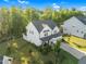 Picture of the property highlighting the green lawn and mature trees surrounding the home at 6404 Fauvette Lane Ln, Holly Springs, NC 27540