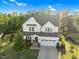 Aerial view of the home's front exterior with a well manicured lawn and a two-car garage at 6404 Fauvette Lane Ln, Holly Springs, NC 27540