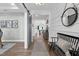 Hallway showcasing wood floors, sliding barn door, access to dining, and a stylish bench for a cohesive design at 6404 Fauvette Lane Ln, Holly Springs, NC 27540