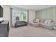 Inviting living room with a neutral color palette, tree-themed accent wall, and comfortable seating at 6404 Fauvette Lane Ln, Holly Springs, NC 27540