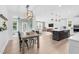 Open-concept living space featuring a dining area, a modern kitchen, and a comfortable living room at 6404 Fauvette Lane Ln, Holly Springs, NC 27540