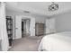 Bright main bedroom featuring tray ceilings, a decorative cabinet, and ensuite bathroom access at 6404 Fauvette Lane Ln, Holly Springs, NC 27540