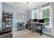 Bright home office featuring a large window, music instruments, stylish desk, and a comfortable ergonomic chair at 6404 Fauvette Lane Ln, Holly Springs, NC 27540