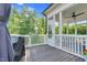 Outdoor screened in porch with wood floors, outdoor fan, and screened windows that view the outdoor foliage at 6404 Fauvette Lane Ln, Holly Springs, NC 27540