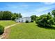 Spacious backyard with lush green grass and mature trees provides a serene outdoor space at 70 Fieldside Dr, Louisburg, NC 27549