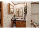 Bathroom featuring a vanity, sink, and mirror with decorative wallpaper at 70 Fieldside Dr, Louisburg, NC 27549
