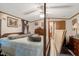 A cozy bedroom featuring a four-poster bed, ceiling fan, and traditional decor at 70 Fieldside Dr, Louisburg, NC 27549