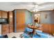 Dining area featuring a ceiling fan, wood paneling, and classic decor at 70 Fieldside Dr, Louisburg, NC 27549