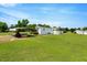 Exterior view of home with a carport, lush lawn, and blue sky at 70 Fieldside Dr, Louisburg, NC 27549