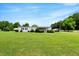 Sprawling front yard and exterior view of a single story home with covered parking at 70 Fieldside Dr, Louisburg, NC 27549