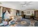 Living room featuring a ceiling fan, carpeting, comfortable seating, and traditional decor at 70 Fieldside Dr, Louisburg, NC 27549