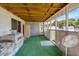 Enclosed porch with green flooring, wood ceiling, and a view of the backyard at 70 Fieldside Dr, Louisburg, NC 27549