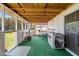 Enclosed porch featuring green flooring, a wood ceiling, and an exterior view at 70 Fieldside Dr, Louisburg, NC 27549