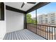 Relaxing balcony space with black railings and views of trees and buildings at 710 W North St # 102, Raleigh, NC 27603