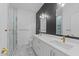 Modern bathroom boasts a double vanity, stylish lighting, and a glass-enclosed shower with marble tile at 710 W North St # 102, Raleigh, NC 27603