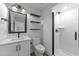 Modern bathroom with sleek vanity, black accents, and a frameless glass shower at 710 W North St # 102, Raleigh, NC 27603