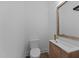 Modern half bathroom with wood vanity, sink, mirror, and toilet at 710 W North St # 102, Raleigh, NC 27603