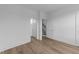 Bright bedroom featuring wood floors, white walls, and access to closet and bathroom at 710 W North St # 102, Raleigh, NC 27603