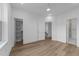 Bright bedroom featuring wood floors, white walls, and a ceiling fan with access to a walk-in closet and bathroom at 710 W North St # 102, Raleigh, NC 27603