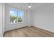 Bright bedroom featuring wood floors, white walls, ceiling fan and a large window providing exterior views at 710 W North St # 102, Raleigh, NC 27603