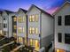 Charming front exterior view showcasing modern architecture and inviting curb appeal at dusk at 710 W North St # 102, Raleigh, NC 27603