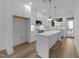 Bright, open kitchen with a center island, white cabinetry, and stainless steel appliances at 710 W North St # 102, Raleigh, NC 27603