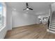 Open living space with wood floors, ceiling fan, and staircase leading to the upper level at 710 W North St # 102, Raleigh, NC 27603
