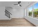 Bright living room with wood floors, ceiling fan, and natural light from large windows at 710 W North St # 102, Raleigh, NC 27603