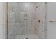 A glass enclosed shower showcases marble tiling and bronze fixtures at 710 W North St # 102, Raleigh, NC 27603