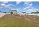 Spacious backyard with a white fence, an assortment of toys, and play equipment at 72 Ina Rose Ln, Four Oaks, NC 27524