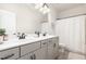 Bathroom featuring double sinks, modern fixtures, and a shower behind a curtain, offering a clean and functional design at 72 Ina Rose Ln, Four Oaks, NC 27524