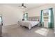 Bright bedroom with large windows, neutral carpet, and a comfortable seating area at 72 Ina Rose Ln, Four Oaks, NC 27524