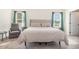Spacious bedroom with neutral carpet, a gray upholstered headboard and plenty of natural light at 72 Ina Rose Ln, Four Oaks, NC 27524