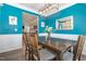 Bright dining room with light fixture, wood table and dining set, adjacent to the kitchen at 72 Ina Rose Ln, Four Oaks, NC 27524