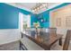 Dining room featuring a modern chandelier and large dining table with bench and chairs at 72 Ina Rose Ln, Four Oaks, NC 27524