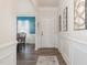 Inviting entryway with hardwood floors, white wainscotting, and an open view into the dining room at 72 Ina Rose Ln, Four Oaks, NC 27524