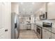 Well-lit kitchen features stainless appliances, granite countertops and modern gray cabinetry at 72 Ina Rose Ln, Four Oaks, NC 27524